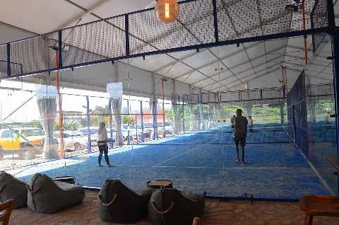 Pistes de padel bleues couvertes et entourées de parois vitrées